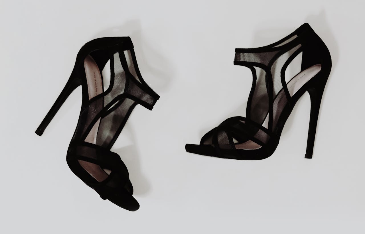 Stylish black high heel sandals with mesh design, ideal for fashion and footwear imagery.